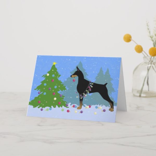 Doberman Decorating Tree in the Forest Holiday Card