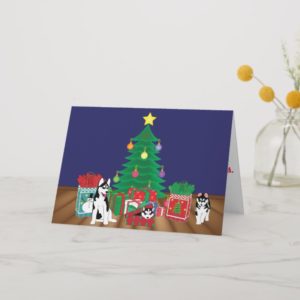 Huskies Playing Under the Christmas Tree Card